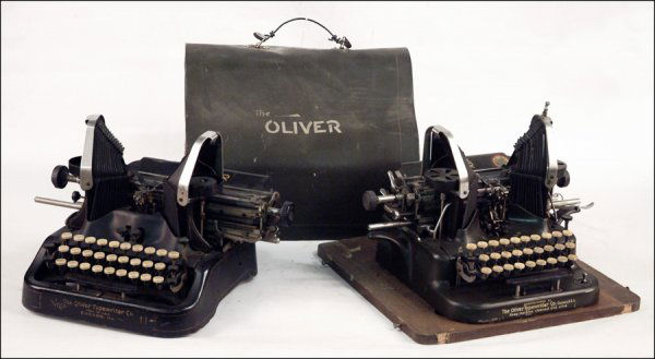 TWO OLIVER TYPEWRITERS.: TWO OLIVER TYPEWRITERS. comprising a Model 11. No. 1000934, and a Model 5, No. 415962, with oak base and metal cover *Condition: No Specific Condition Recorded - Sold As Is *Est. Sale Time: 8:54 AM Ce