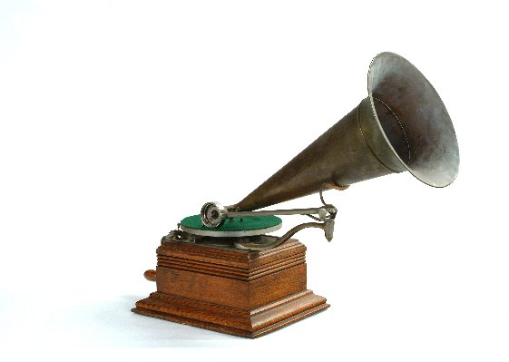 Zonophone Model C Phonograph,: No. 42767, with 7-inch turntable, record spring, (reprduction)V-Concert soundbox, cast bedplate with English and Russian labeling, nickeled traveling and extension arms, light oak case, and brass horn