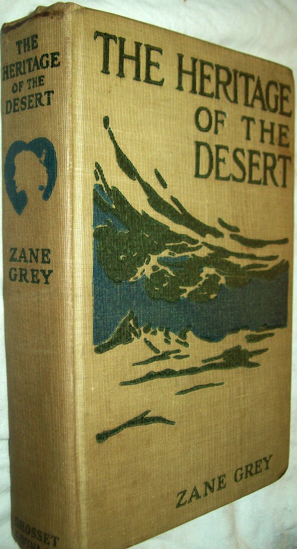 The Heritage of the Desert by Zane Grey HB (1910): The Heritage of the DesertZane GreyGrosset & Dunlap. 1910. Decorated grey cloth cover which has embossed images of a mountain and clouds in green and blue. advertisements of other books listed on the 