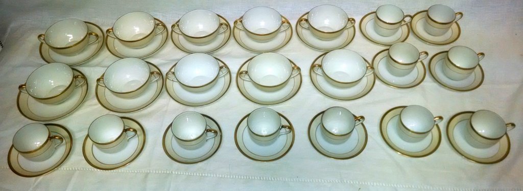 Lot of (21) Noritake Nippon China Cups & Saucers: This lot contains (10) Cream Soup & Saucers 2" H x 3.5" D and (11) Demitasse Cups and Saucers 2.25" H x 2.5" D. All are decorated with gold rims and accents.