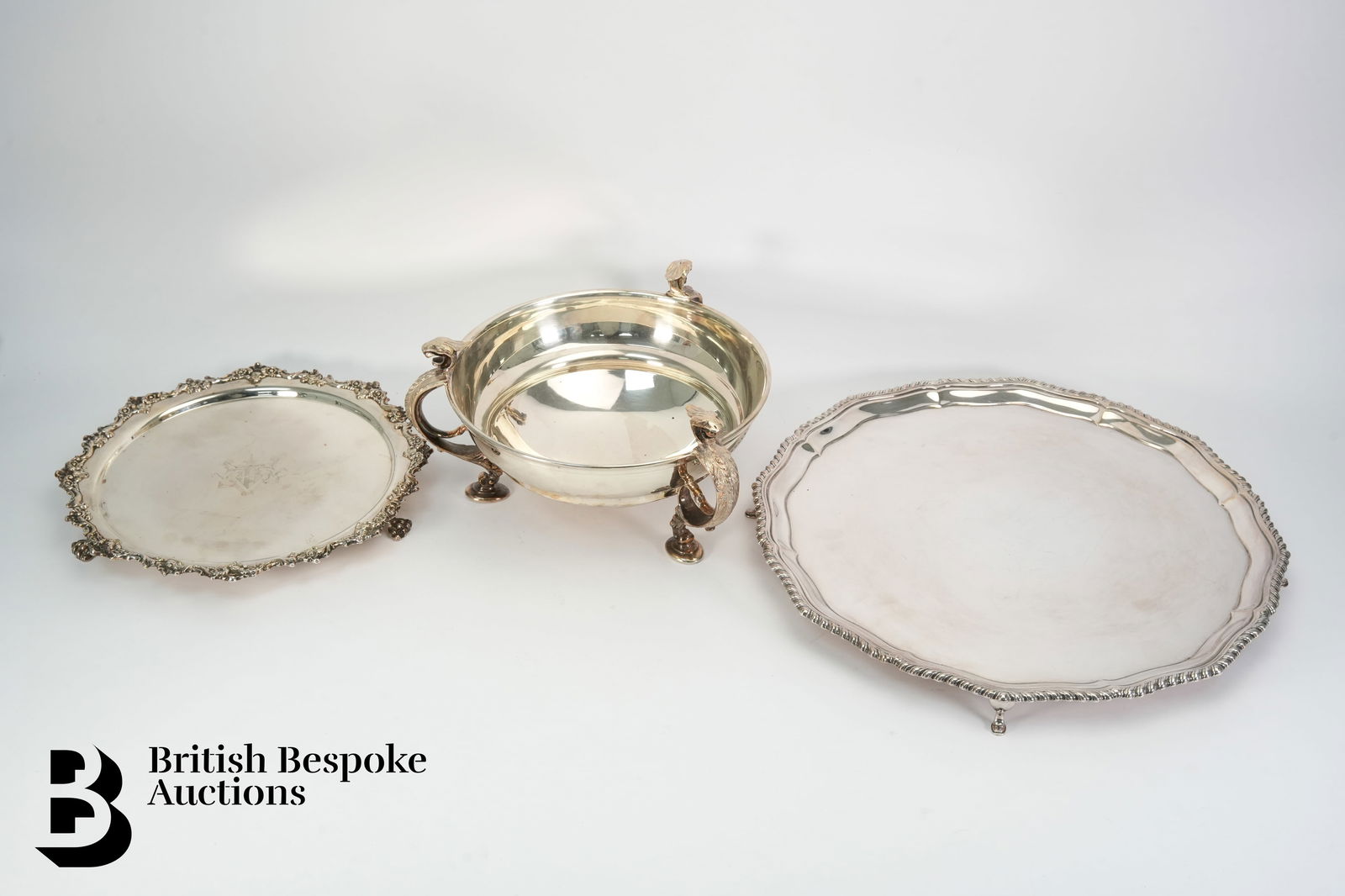 Good Quality Silver Plate: A good quality silver plated presentation bowl, supported on three legs cast with griffin, mm Mappin & Webb, approx 26 cms diameter x 15 cms h. This lot includes a large silver plated circular ser