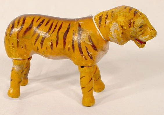 Schoenhut Humpty Dumpty Circus Tiger: Schoenhut Humpty Dumpty Circus Tiger: No tail, overall wear & losses to lower jaw area; old touch up to paint on head & back of neck, restrung (?) over all wear. 5" T x 7 1/2" W. All items sell As Is,