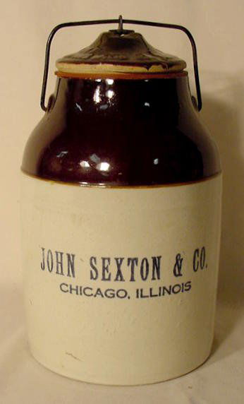 Stoneware Preserves Jar NR: Stoneware preserves jar w/ original locking lid; black stamped wording on front "John Sexton & Co., Chicago, Illinois." Base w/ impressed No. 44; wording on lid not legible. (Tiny glaze flakes on lid