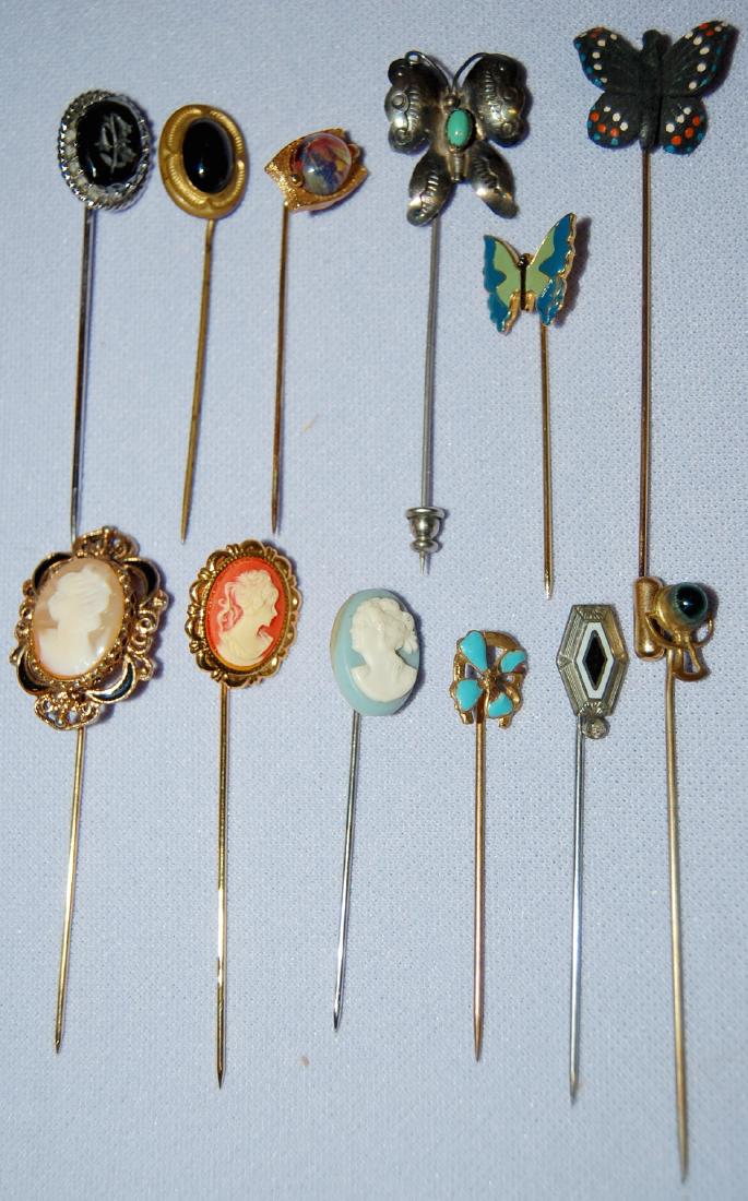 12 Vintage Costume Jewelry Stickpins: 12 Vintage Costume Jewelry Stickpins, Unmarked: Includes Cameo, Intaglio, Butterfly, Flower and More. There is one shell cameo plus a silver and turquoise one. All sell as is, where is.