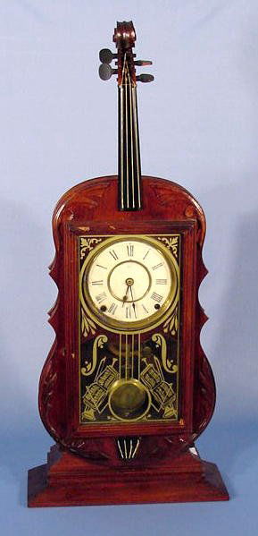 Seth Thomas Figural Violin Mantel Clock NR: Seth Thomas Violin Mantel Clock: walnut case with a 6" metal dial, a signed time and strike movement with No. 5 7/8, and a patent date of Dec 28,1875. (The lower strings are tattered, some chips and n