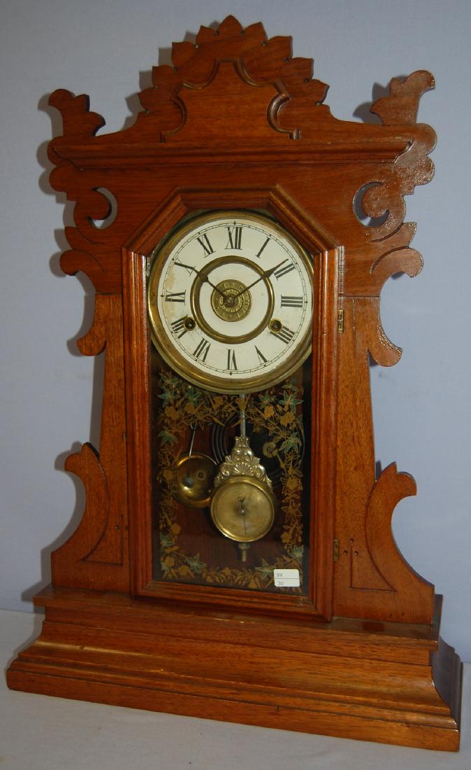 New Haven Walnut "Shamrock" Kitchen Clock: New Haven Walnut "Shamrock" Kitchen Clock. T.S. & alarm, unsigned paper dial, has a Patent Dial Pendulum, gong & bell strike, colored stenciled door glass, rear paper label. Has not been tested. Sells