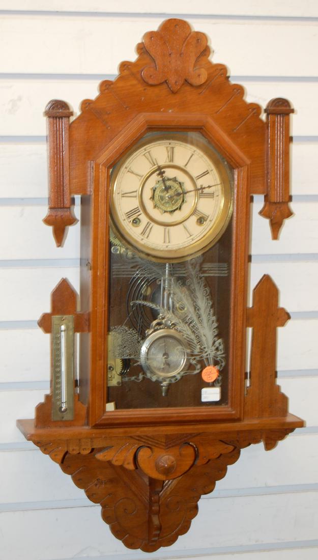 Antique Ornate Waterbury Hanging Kitchen Clock: Antique Ornate Waterbury Hanging Kitchen Clock: T&S with Alarm, a Waterbury compensated pendulum, side brass and glass thermometer and a stenciled door. Has not been tested. Sells as is, where is.