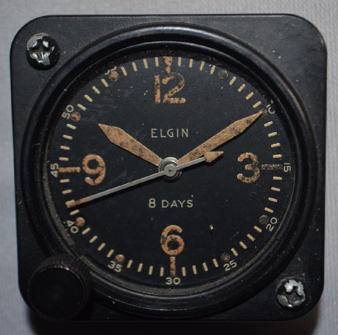 Elgin 8 Day Bakelite Military Aviation Clock: Elgin 8 Day Bakelite Military Aviation Clock: The black dial is marked \"Elgin 8 Day\" and the back is marked \"Adjusted\". (The clock is not working at this time.) Sells as is, where is.