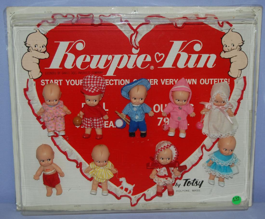 Kewpie Kin Set by Totsy: Kewpie Kin Set by Totsy: There are nine 4" vinyl dolls set in a plastic display case that stands up. All sell as is, where is. Case - 13 1/2" x 18"