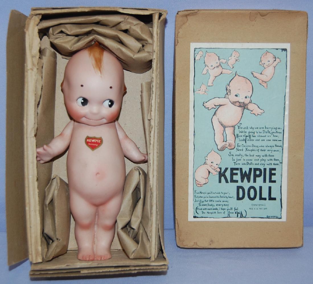 Antique Bisque Kewpie Doll in Original Box: Antique Bisque Kewpie Doll in Original Box With Labels: Germany, pinted features, eyes looking left; jointed arms; marked O'Neill 4; heart label (German Doll Co.) and black cricle label on the back. I