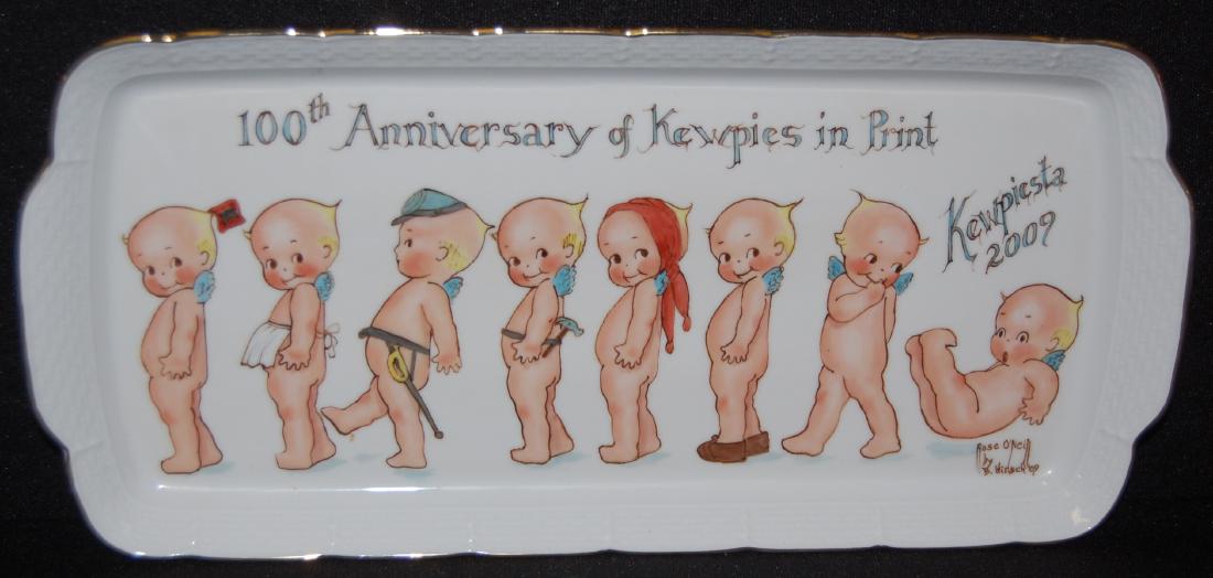 100th Anniversary of "Kewpies in Print" Tray: Kewpiesta 2009' 100th Anniversary of "Kewpies in Print" Porcelain Tray by the Czech Republic: The white tray with gold trim was hand painted by B. Hirsch '09. There are 8 Rise O'Neill Kewpies - Wag, C