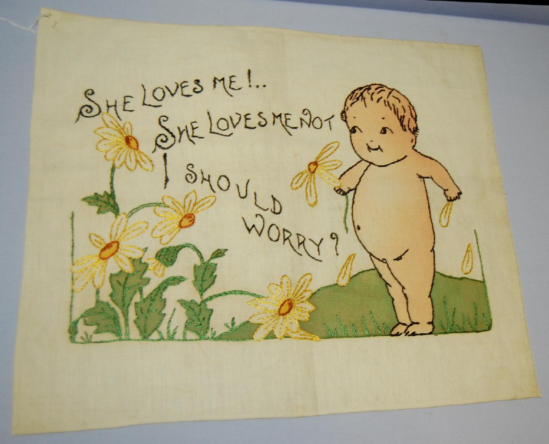 Antique Kewpie Pillow Top, "She Loves Me": Antique Kewpie Pillow Top, "She Loves Me": It is embroidered and tinted. Titled "She Love Me! … She Loves Me Not … I Should Worry". There is a Kewpie baby and daisies in the decoration. Sells as i