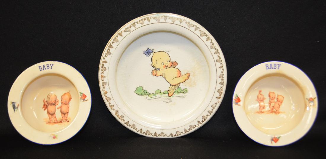 3 Antique Kewpie Decorated Baby Dishes: 3 Antique Kewpie Decorated Baby Dishes: 1.) Holdfast plate, E. Liverpool, O. with Chief Wag transfer (Crazed pottery. 8 1/4" Dia. 2. and 3.) Czechoslovakia "Baby" bowls, 5 3/8" Dia. (Stained) All sell