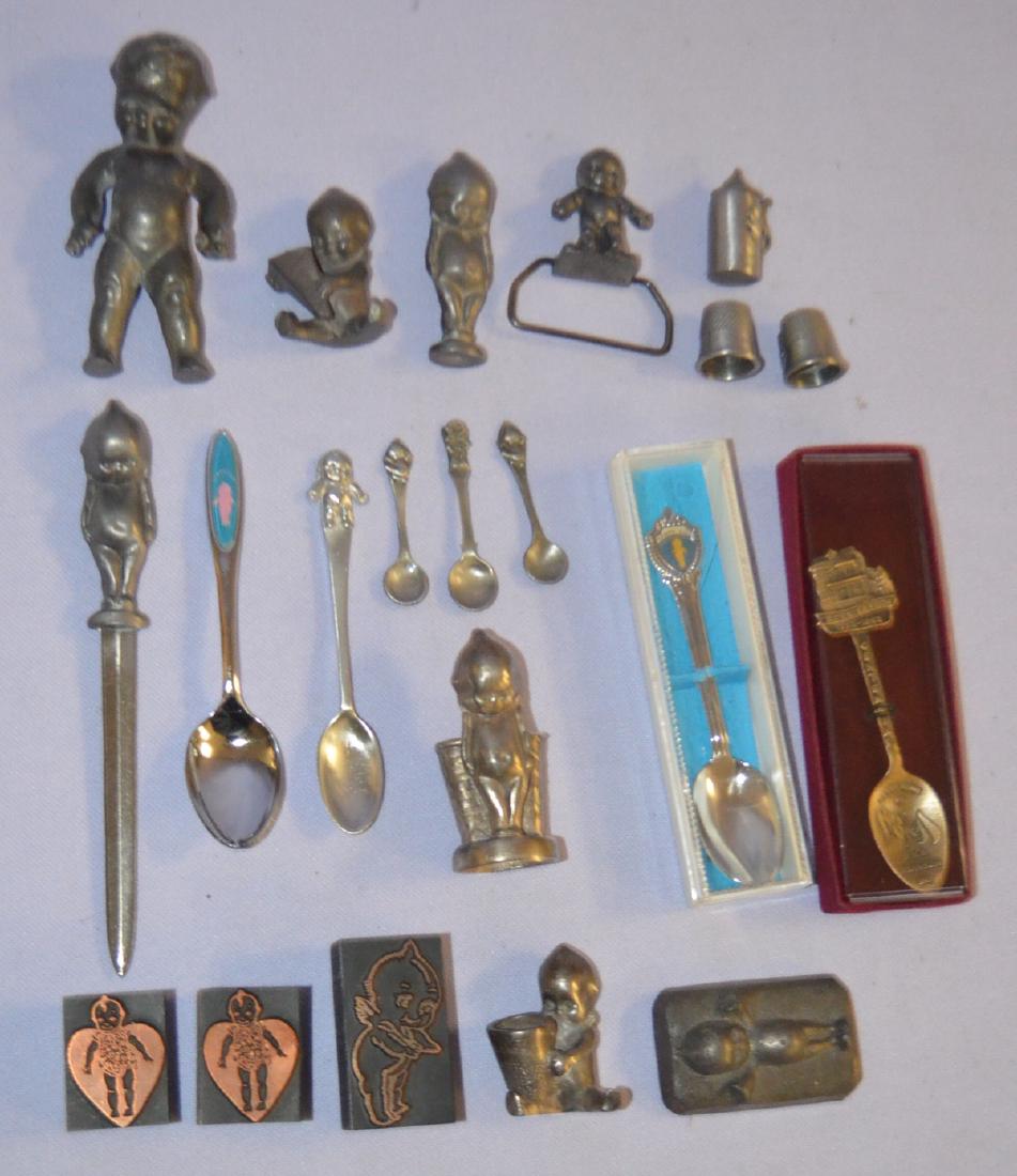 21 Kewpie Metal Collectibles: 21 Kewpie Metal Collectibles: 1.) 3 Kewpie ink stamps. 2.) 3 Pewter minitaures, 2 thimbles and a stein. 3.) 3 minature spoons, 1 marked pewter and 1 marked Branson, Mo. 4.) 4 Kewpie spoons, 1 American