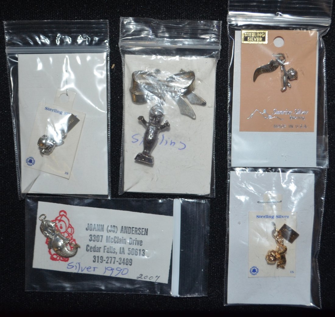 5 Sterling Silver Kewpie Jewelry Collectibles: 5 Sterling Silver Kewpie Jewelry Collectibles: 3 figural Kewpie charms (One is gold colored but tagged Sterling), bow pin with charm and Merkewp charm. All sell as is, where is.