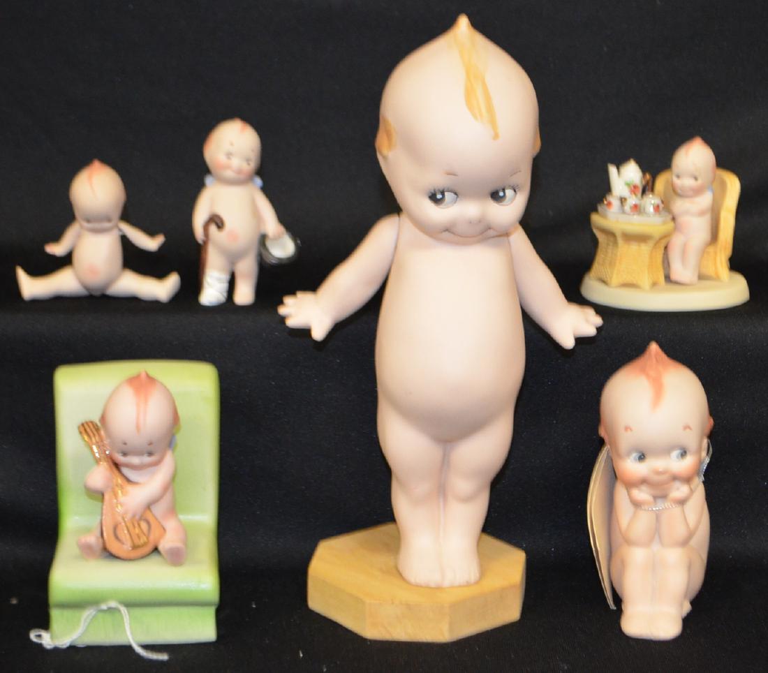 5 Bisque Kewpies by Darlene 1976 - 2003: 5 Bisque Kewpies by Darlene: 1976 Thinker, 5"; 1985 Fully Jointed Kewpie, 3 1/2"; 1989 Seated Kewpie at Tea Table, 3 1/4" x 3 1/2"; 1990 Injured foot Kewpie, 3 1/2"; 2003 Mandolin player seated on big
