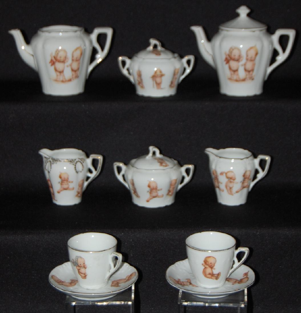 10 Piece Bavaria Kewpie Child's Tea Set: 10 Pieces Bavaria Kewpie Child's Tea Set, Mrs. Rose O'Neill Wilson: transfer decoration, gold trimmed: 2 tea pots, 2 sugars, 2 creamers, 2 cups, 4 saucers. (Cups are chipped.) All sell as is, where is
