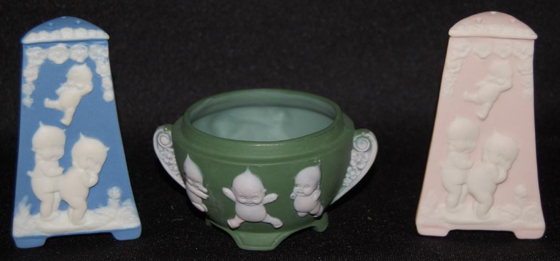 3 Kewpie Decorated Jasperware Collectibles: 3 Kewpie Decorated Jasperware Collectibles: 1.) Green sugar, 6 Kewpies. (No lid.) 2.) Pink shaker, 3 Kewpies. 3.) Blue shaker, 3 Kewpies. All sell as is, where is.