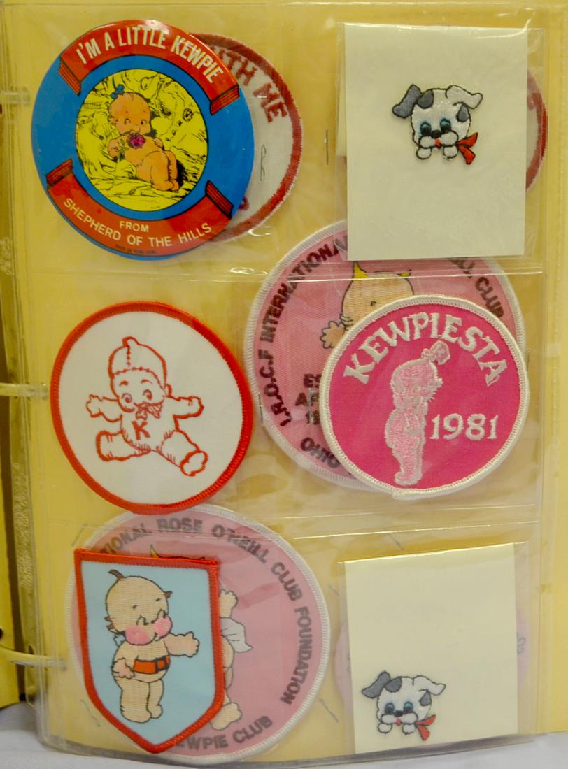 Notebook- Kewpiesta & Kewpia Memorabilia: Notebook- Kewpiesta & Kewpia Memorabilia: Approx. 175 Pieces; includes luggage tags; sew on patches; pinback and pinch back buttons; key fobs; Calendar; Thermometers; Clicker toy; hand held marble gam