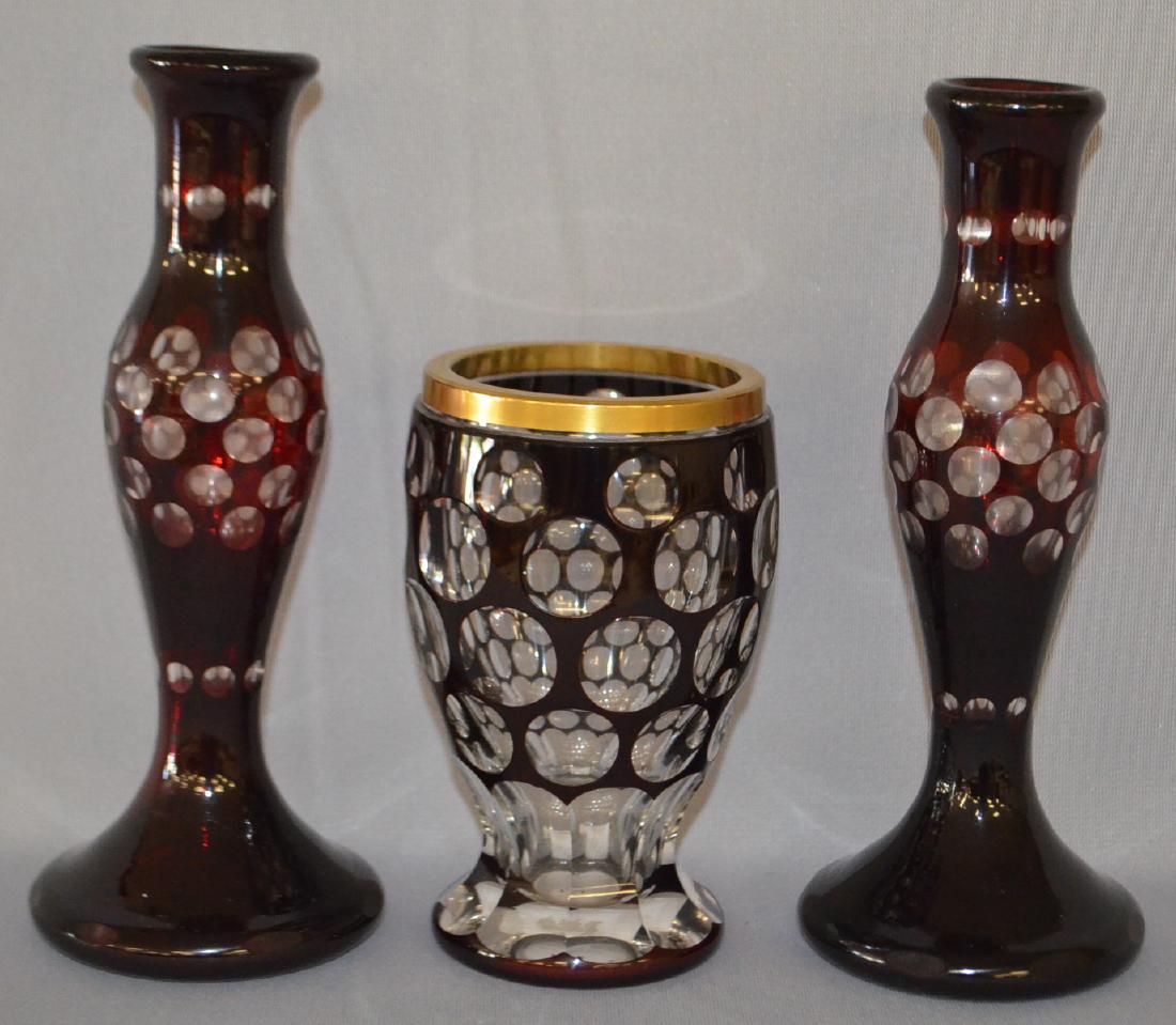 Three Ruby Cased and Cut Back Glass Items: Three Ruby Cased and Cut Back Glass Items: Includes a pair of bud vases and an Optical Circle Goblet with a gold rim. All sell as is, where is. Tallest - 8"