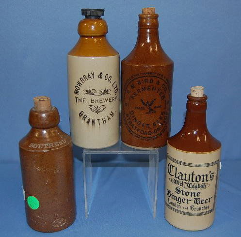 4 English Stoneware Beer Bottles: 4 English Stoneware Beer Bottles: 1.) Brown and tan "Clayton's Old English Stone Ginger Beer-London & Branches". Also with impressed mark "Bourne 33 Denby"; 2.) Dark brown glaze with B & Co. on the sh