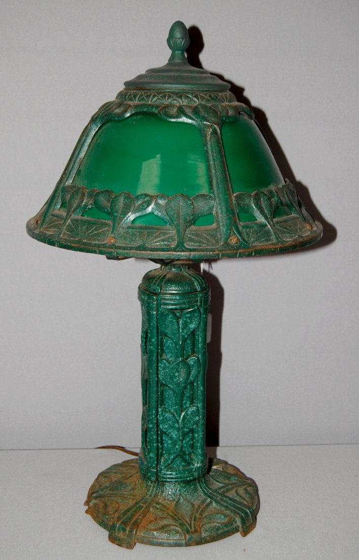 Antique Heavy Ornate Industrial Style Table/Desk Lamp: Antique Heavy Ornate Industrial Style Table/Desk Lamp. Heavy lamp w/ green painted base w/ leafy pattern, some wear, chips, and needs cleaned well; matching shade is a 1 piece green over white shade w