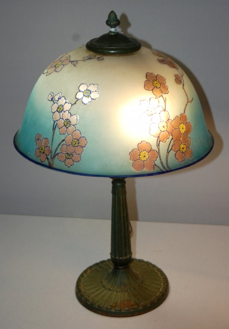 Obverse Painted Table Lamp on Iron Stick Base: Obverse Painted Table Lamp on Iron Stick Base. Attributed to Pittsburgh. Blue shade on green base w/ acorn finial and acorn pulls. Overall- 21.5" tall. Condition- Shade has some roughness around apert