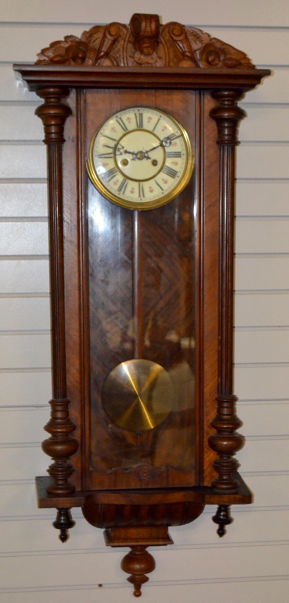 Walnut Carved German Vienna Regulator. T&S, decorated: Walnut Carved German Vienna Regulator. T&S, decorated unsgined 7 1/2" porcelain dial; has pendulum. Carved scroll crest with side columns. Not tested. F.O.B- Freight On Buyer. 45" T