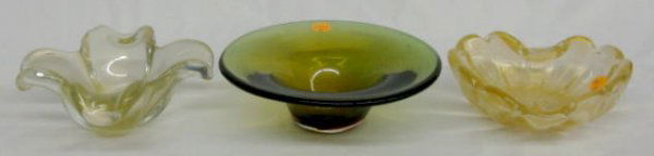 3 Murano Glass Items: 3 Murano Glass Items: 1.) Clear, heart shaped dish with gold flecks, 6 3/4" x 7" 2.) Round greenish amber dish with ground bottom, 2 1/2" x 7 3/4" 3.) 4 Petal floriform dish, clear with gold flecks, 7