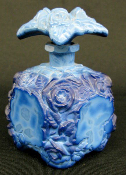 Blue Malacite Glass Perfume Bottle: Blue Malacite Glass Perfume Bottle: the rose design is highlighted by flat panels on the sides. Not marked, but is a Czechoslovakian made item. (The stopper is stuck in place.) 5 1/2" tall.qq All Item