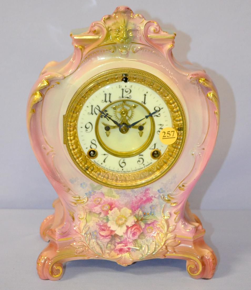 Antique Ansonia (La Plaine) Porcelain Mantle clock: Antique Ansonia (La Plaine) Porcelain Mantle clock, 5" signed cream porcelain visible escape dial, signed movement T&S gong strike, Pink & Ruby Royal Bonn floral design case with lion figure at top. 1