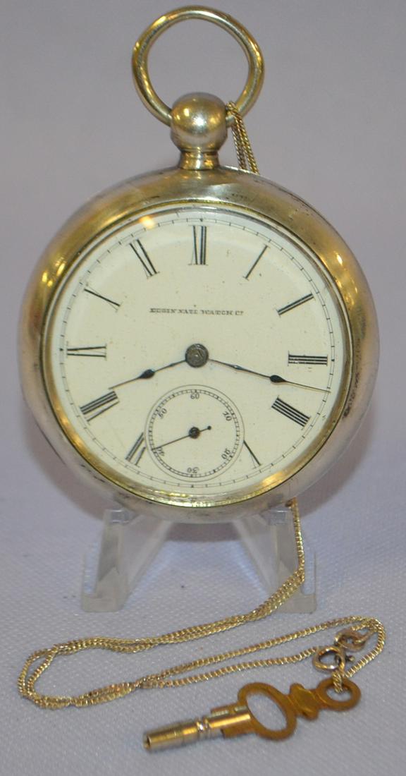 Elgin 7-17j KW Coin Pocket Watch: Elgin 7-17j KW Coin Pocket Watch. 18s pf KS full No. 2474677, runs in a white No. 9351 coin silver case w/ key. Dust cover is dented, lock design on chain worn.
