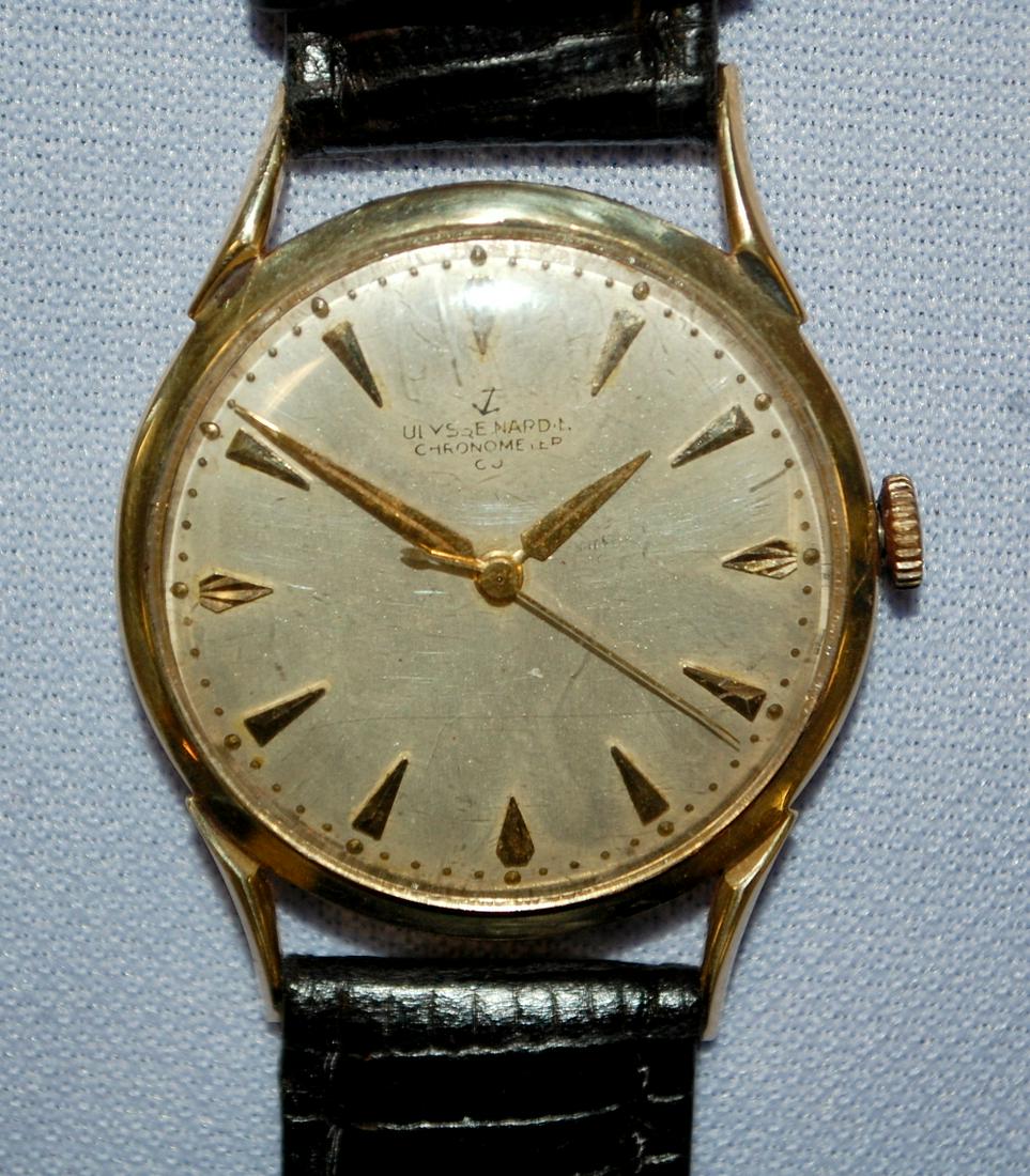14K YG Ulysse Nardin Mens 17J Wrist Watch: 14K YG Ulysse Nardin Mens 17J Wrist Watch: Swiss, adjusted temp, Serial No.5525529, case No.E21043, running, silver dial with gold features has many scratches from someone cleaning it, the gold featur