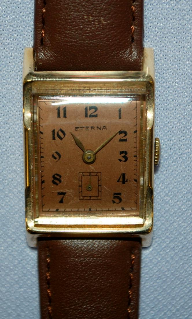 14K YG Eterna Mens Wrist Watch: 14K YG Eterna Mens Wrist Watch: Serial No.3107337, not running, case back and fancy bezel has 14K hallmarks, copper dial with black features is ok, on modern leather band.