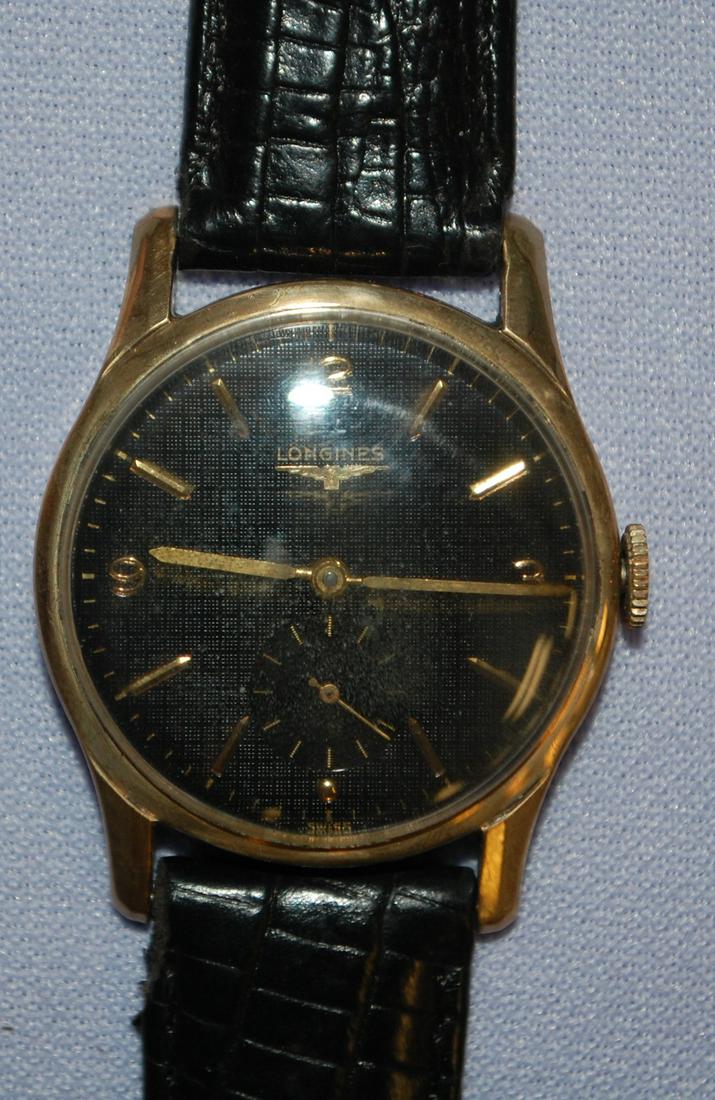 10K GF Longines Wrist Watch: 10K GF Longines Wrist Watch: 17J, 23Z, black waffle pattern dial in great condition, 10K GF Longines-Wittnauer case with black leather band, fine scratches from wear and some small finish loss on lugs
