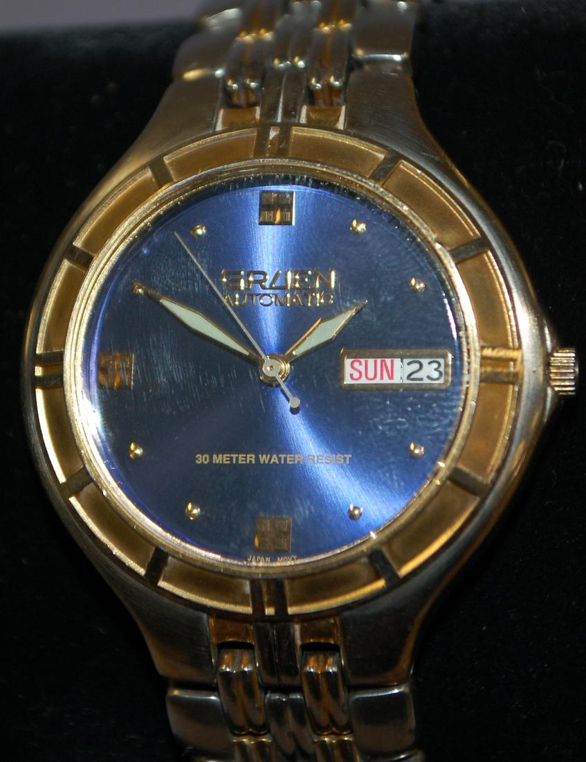 Gruen Automatic 21J Wrist Watch: Gruen Automatic 21J Wrist Watch: 21J Automatic Gruen movement in a 2 tone base metal case w/ light edge wear to finish, visible back, metallic blue dial, 2 tone band has lost most of it's golf finish,