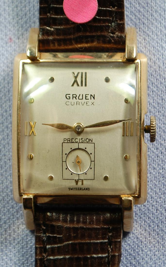 14K YG Gruen 17J Curvex Precision Men's Wrist Watch: 14K YG Gruen 17J Curvex Precision Men's Wrist Watch: no.K42304 on case back, 440-578 inside, silver dial with black and gold features, winder not able to connect, leather band, not running.
