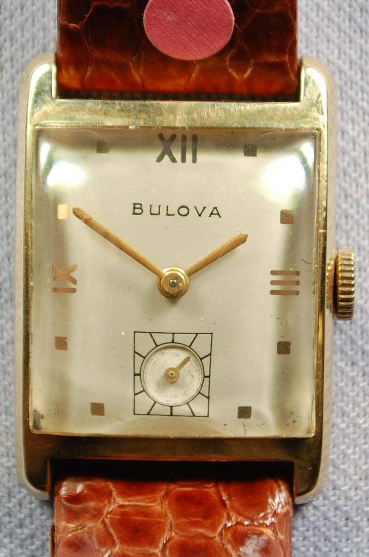14K YG Bulova 17J Men's Wrist Watch: 14K YG Bulova 17J Men's Wrist Watch: case number 7270087, curved silver dial with black and silver features, hands don't look original, runs for a few minutes then stops, it does wind ok.