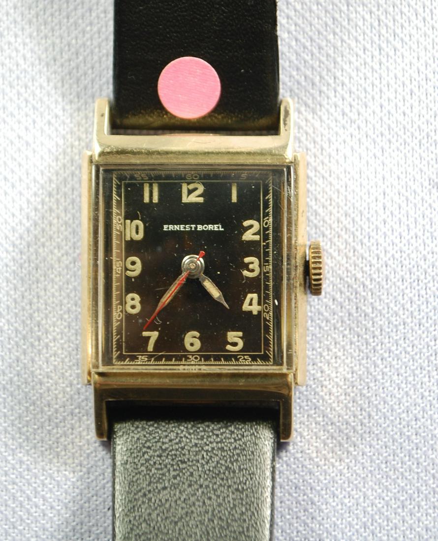 14K YG Ernest Borel 17J Men's Wrist Watches: 14K YG Ernest Borel 17J Men's Wrist Watches: the black curved dial has gold and luminous features, name in white, all in good condition, case no.511395, on a leather band, running.