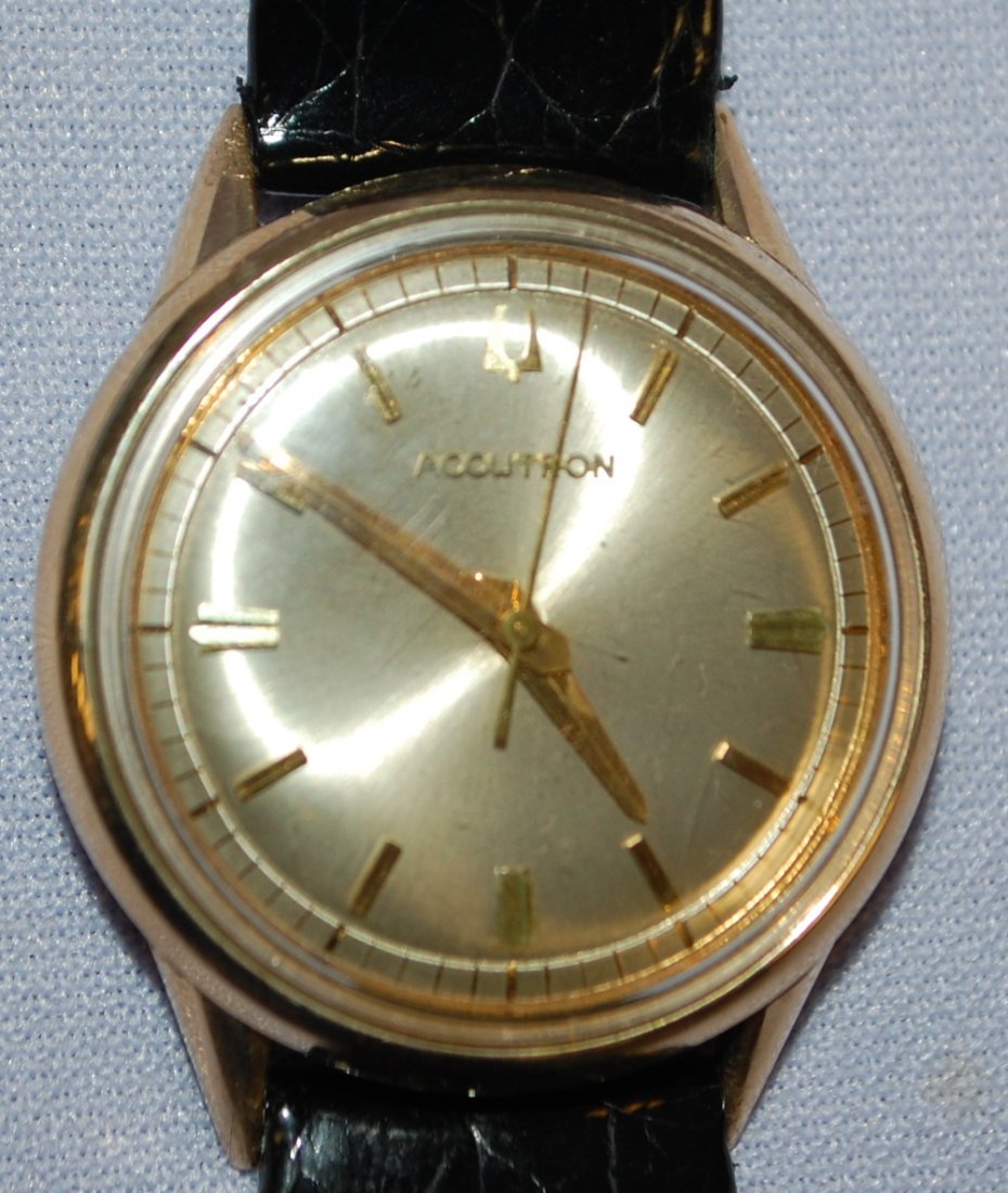Bulova Accutron 10K GF Wrist Watch: Bulova Accutron 10K GF Wrist Watch: 214 movement, clean battery compartment, 10K GF bezel, stainless steel back, nice dial, black leather band, not tested.