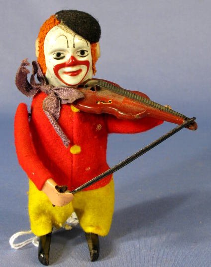 Schuco Key Wind Clown Fiddler Toy: Schuco Key Wind Clown Fiddler Toy: dressed in colorful felt clothing his feet, face, fiddle and bow are tin. He has a very good appearance and an unmarked key that fits. 4 1/2" tall and works well All