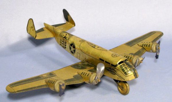 Marx 4 Prop Bomber Tin Windup Toy Plane: Marx Tin Windup 4 Prop Bomber Toy Plane: coil spring driven with a black and gold finish. (The plastic props are all broken. The drive system still works. There is some wear and areas of corrosion.) 1