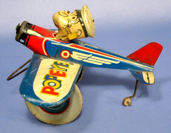 Popeye The Pilot Tin Clockworks Airplane: Popeye The Pilot Tin Clockworks Airplane: dated 1940 for King Features, made by Marx, but not marked. (The spring is intact, winds just fine, but does not unwind to move the plane when released. The w
