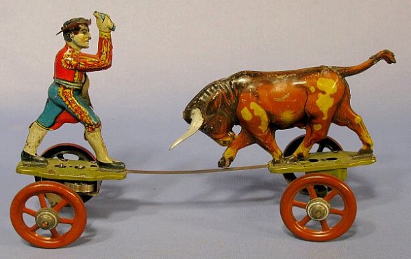 German Bull Fighter w/Bull Tin Windup Toy: German Tin Windup Bull Fighter w/Bull Toy: simply marked D.R.P., it is formed to resemble a roller skate. On one end is the charging bull, the other has a colorful bull fighter. A flat metal spring se