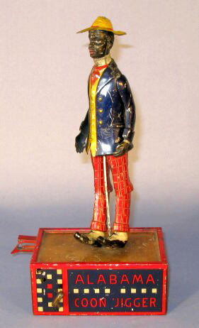 Lehmann Alabama Coon Jigger Tin Windup Toy: Tin Toy Windup Lehmann Alabama Coon Jigger: No.685, when working the figure does a jig like dance on his platform. The hole in his right hand is for inserting a national flag. (The key does not work.