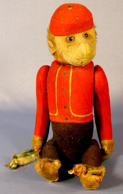 Schuco Bell Hop Monkey w/Glass Eyes Toy: Schuco Bell Hop Toy Monkey w/Glass Eyes: when the tail is twisted, the head moves around. The arms and legs are jointed at the shoulders and hips. (One ear is gone. The Mohair is heavily worn. The fel