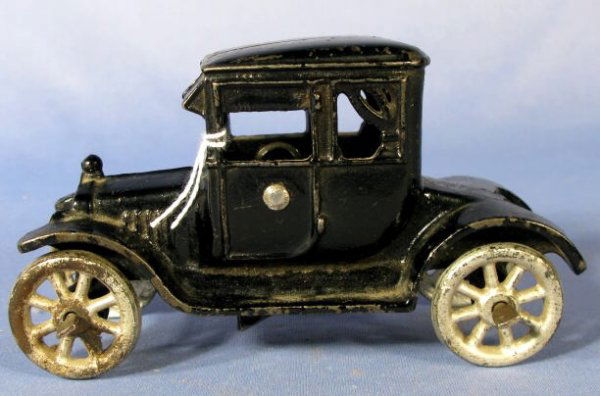 Roadster w/Metal Spoke Wheels Cast Iron Toy: Cast Iron Toy Roadster w/Metal Spoke Wheels: painted black and unmarked. The back windows have simulated curtains and the rear end, a deep open place between the fenders. (The paint has a few scattere