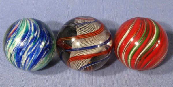 3 Marbles: Latticino, End of Day & Onionskin: 3 Marbles, Latticino, End of Day & End of Day Onionskin: never ground. 1.) The latticino is 1 3/4" with red, white and blue swirls. It has 2 pontils. (Has never been ground and has some light surface