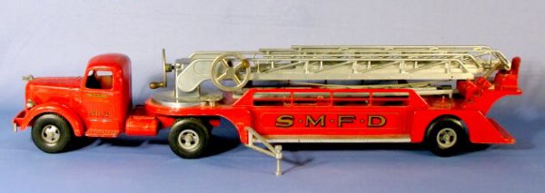 Smitty "L" Mack Aerial Ladder Truck Toy: Smitty "L" Mack Aerial Ladder Truck Toy: made by Smith Miller, it is marked "S.M.F.D. No.3" and has 8 wheels. The hand crank ladders extend to 40" in length. There are 2 straight ladders with it also.