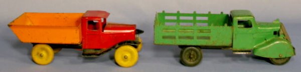 2 Toys: Pressed Steel Stake & Dump Truck: Pressed Steel Stake & Dump Truck: 1.) The dump truck, with wood wheels is red, black and orange. 9 3/4" l 2.) The stake truck is green with tin front. 10" l (One hard plastic wheel is replaced with a